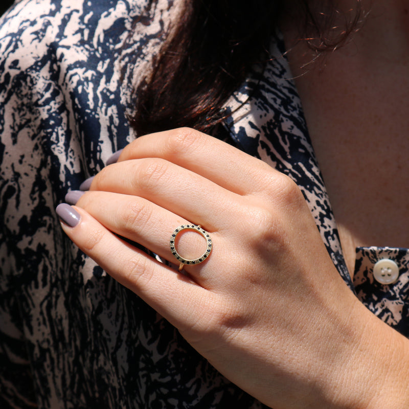 Model wearing Hand made in Los Angeles Brooke Gregson 14k gold black diamond Circle ring